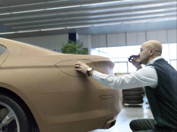 Nader Faghizadeh (Exterior Designer BMW 6 Series Coupe) taping a foiled  clay model of the BMW 6 Series Coupe (03/2011).