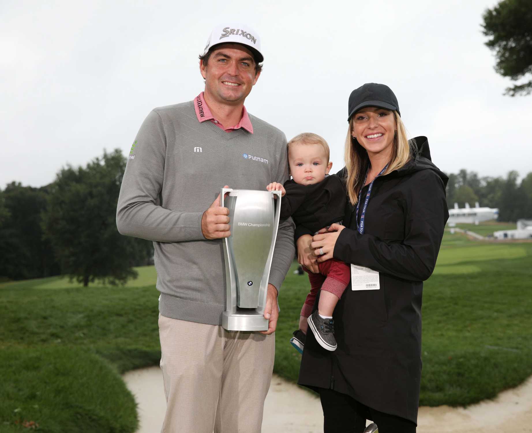 PGA TOUR pro Keegan Bradley holds the BMW Championship trophy alongside his  wife, Jillian, and their son, Logan, following his victory at Aronimink  Golf Club in Newtown Square, PA on Monday, September