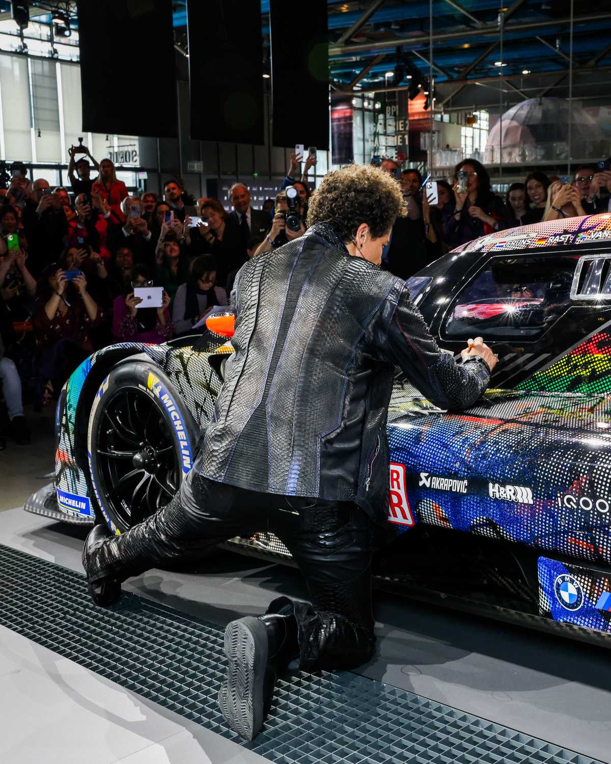 Julie Mehretu signs her BMW Art Car #20 at the world premiere on May 21 ...