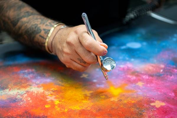 CYRIL KONGO HAND-PAINTING THE STARLIGHT HEADLINER AT ROLLS-ROYCE