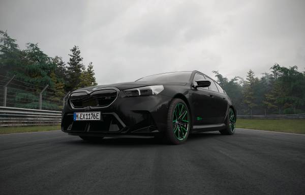 BMW M5 Sedan in Black Sapphire metallic with green wheel accents from the 100 Jahre Nürburgring edition